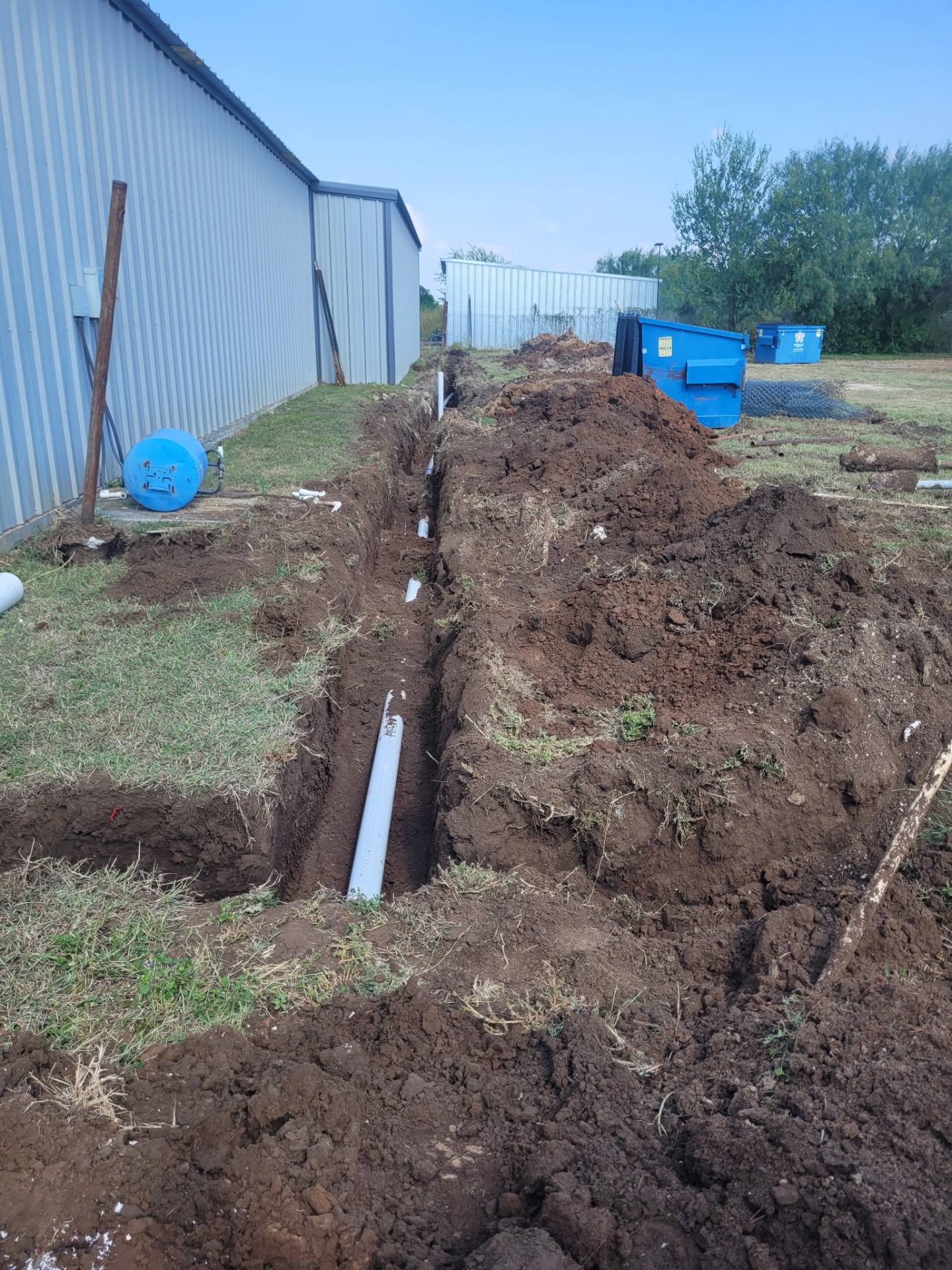 Sewer line replacement trench with new PVC pipe