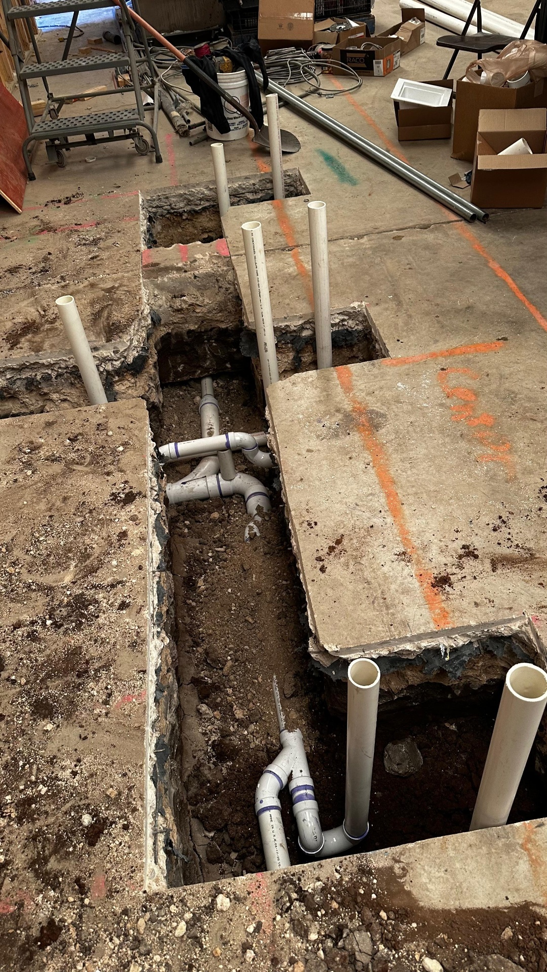 Plumbing rough-in PVC pipes through concrete slab