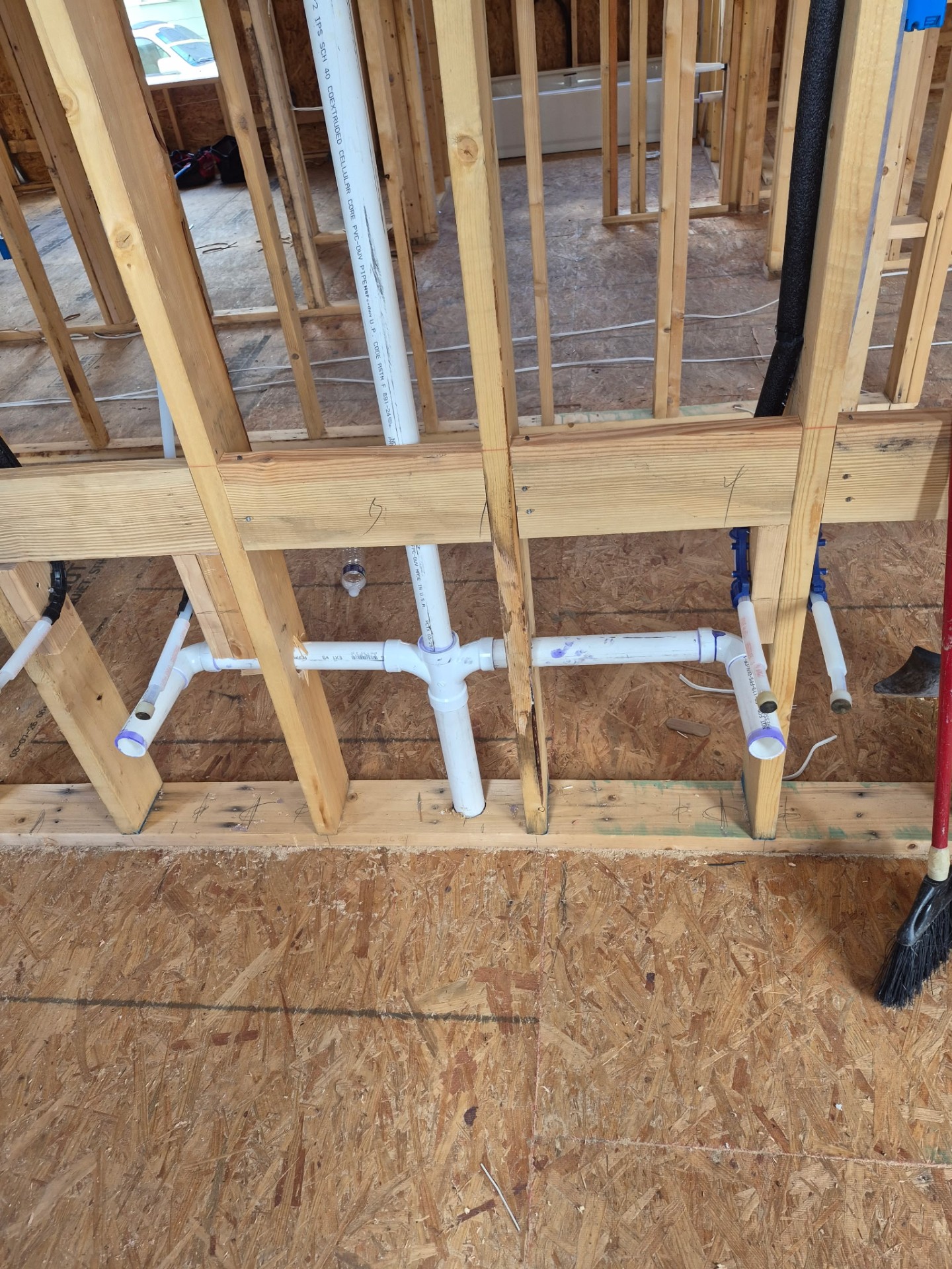 Residential rough plumbing inside wood-framed wall